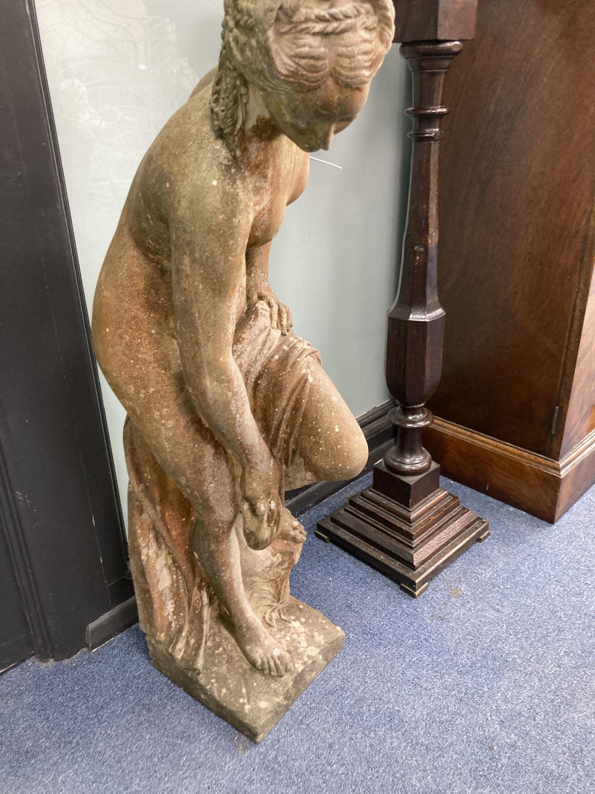 A reconstituted stone garden ornament of a female bather, height 74cm